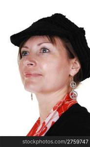 An middle aged woman in an black sweater and a black hat and red scarf standing in the studio, smiling, for a portrait for white background.