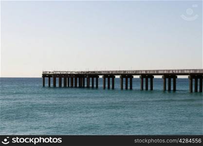 An ocean fishing pier on a calm day