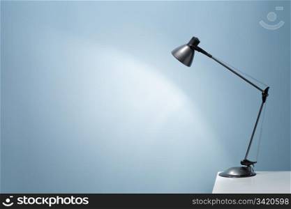 An office desk lamp illuminating the background. Lots of copy space.