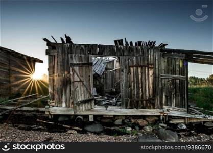 An old abandoned wooden cabins at coastline. Karelia. High quality photo. An old abandoned wooden cabins at coastline. Karelia
