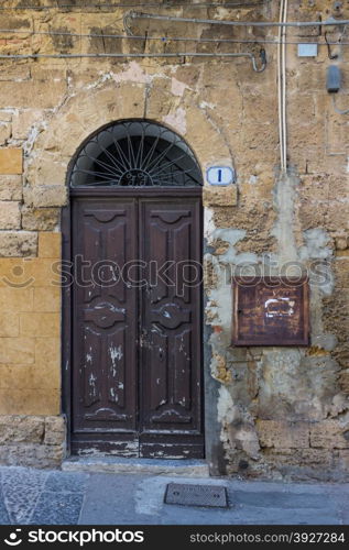 An old brown wooden door in the provence.