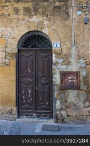 An old brown wooden door in the provence.
