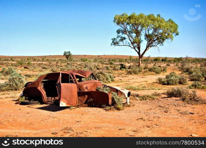 an old car rusts away in the hot desert. old car in the desert