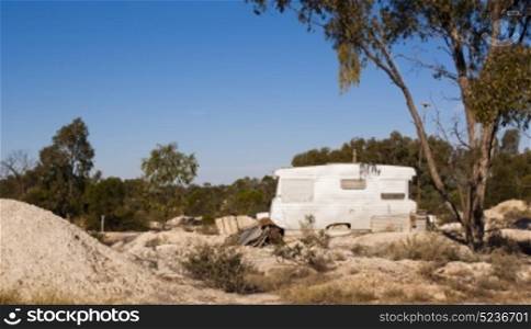 An old caravan sits on an opal mining site in rural Australia