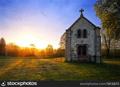 An old chapel during a blazing spring sunset