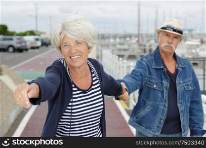 an old couple outside on the port