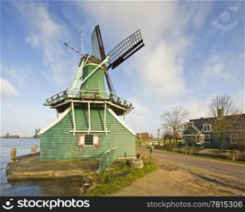 "An old Dutch windmill, used to grind mustard seeds at the tourist attraction "De Zaanse Schans""