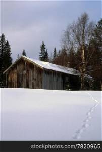 An old farmhouse in snowy landscape
