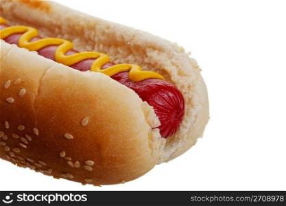 An old-fashioned hot dog with mustard, on a sesame seed bun. Shot on white background.