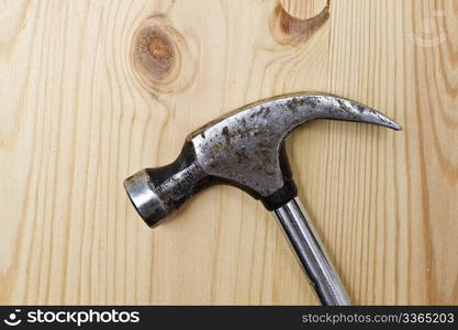 An old Hammer isolated on wood background