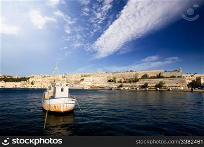 An old harbour with a fishing boat. Valletta, Malta