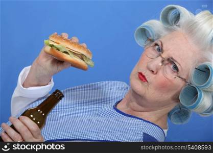 An old lady enjoying a burger