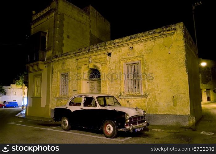 An old Morris parked on a typical Maltese street.