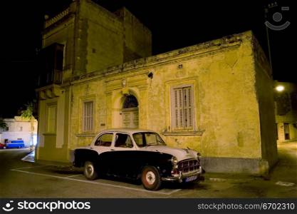 An old Morris parked on a typical Maltese street.