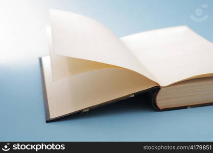 An old open book on blue background