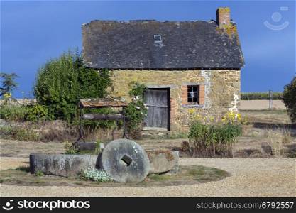 An old rustic farm building in the countryside of Normandie-Maine in northwest France.