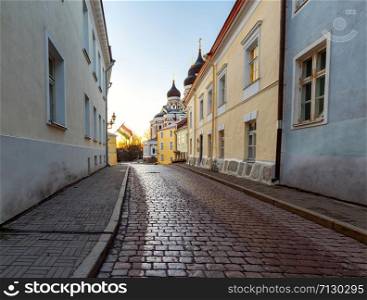 An old street with a cobblestone pavement in the early morning. Tallinn. Estonia.. Tallinn. Old street at dawn.