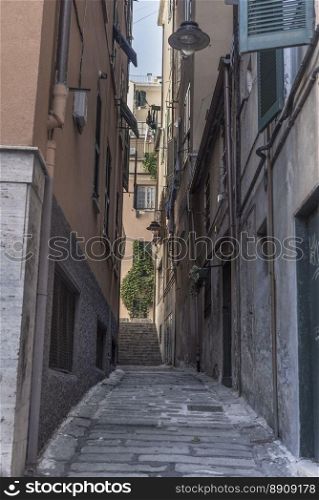 An old tight alley, in the Italian specific antique architecture, in the historical center of Genoa city.