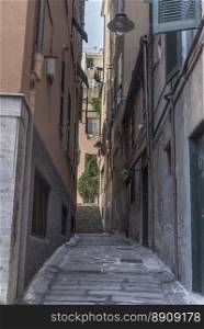 An old tight alley, in the Italian specific antique architecture, in the historical center of Genoa city.