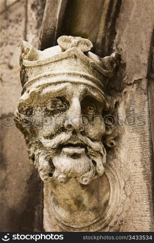 An old weathered statue of King Brian Boru of Ireland as seen on the outside of the Chapel Royal at the Dublin Castle.