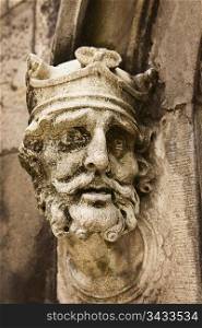 An old weathered statue of King Brian Boru of Ireland as seen on the outside of the Chapel Royal at the Dublin Castle.