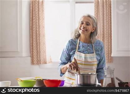 An old woman cooking in her kitchen.