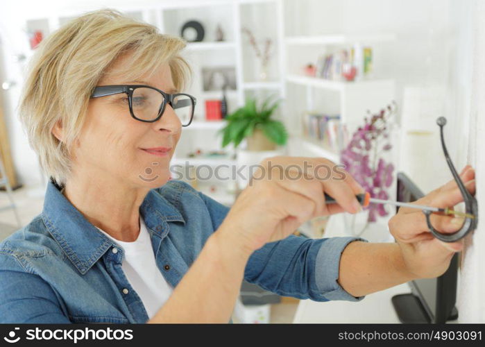 an old woman doing diy