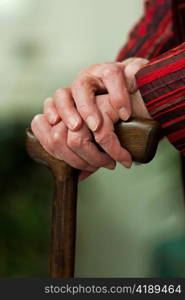 an old woman holding a cane in her hands.