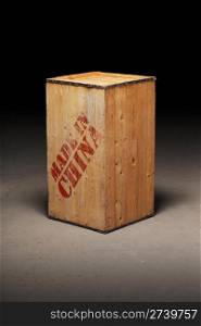 "An old wooden crate with text "Made in China" on dirty concrete floor"