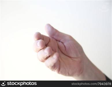 An older man illustrates a point with the help of a hand gesture.