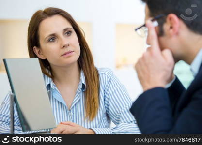 an ophthalmologist doing a visual examination for a customer