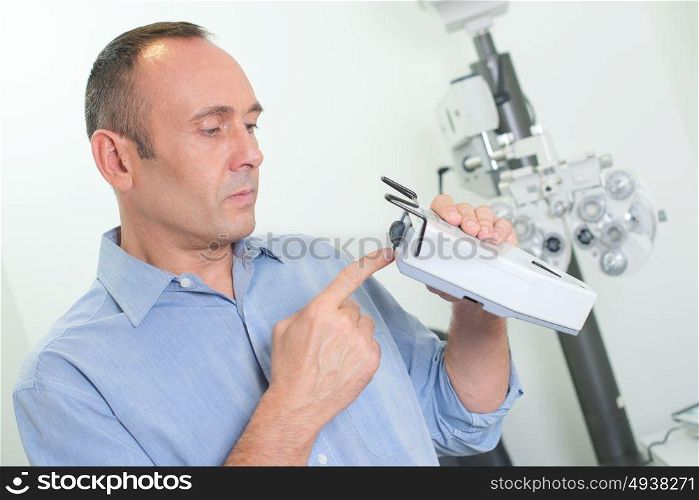 an optician checking the equipment