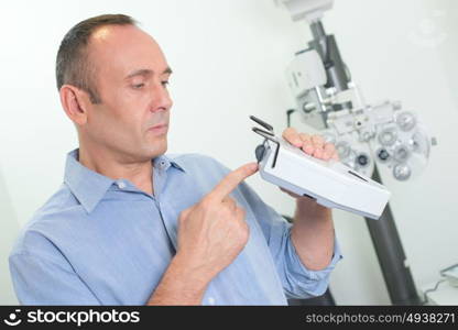 an optician checking the equipment