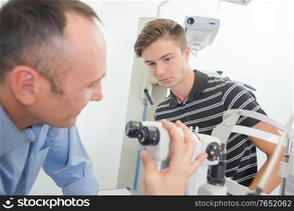 an optician is adjusting equipment