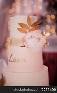 An original high wedding cake decorated with flowers and leaves.. Stylish wedding cake with leaves 3817.