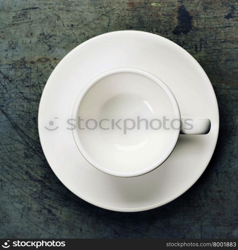 An overhead view of an empty espresso cup on a saucer