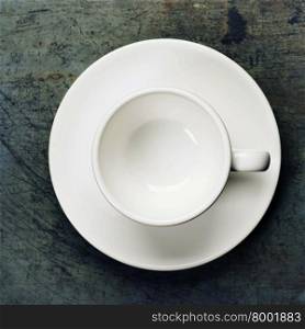 An overhead view of an empty espresso cup on a saucer