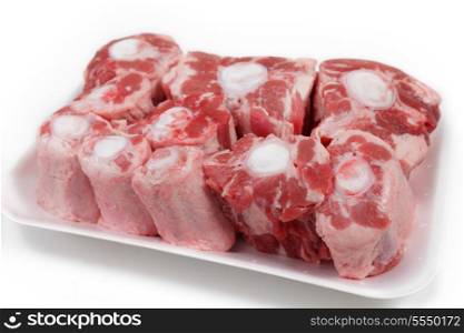 An oxtail, cut into segments and presented on a supermarket-style polystyrene tray