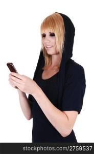 An pretty blond woman with her cell phone is messaging to her friendsin the studio, on white background.