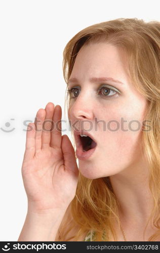An serious teenage girl shouting a warning , with her mouth open andher hand at her face and with blond hair, over white background.