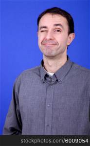 an silly young man portrait over a blue background