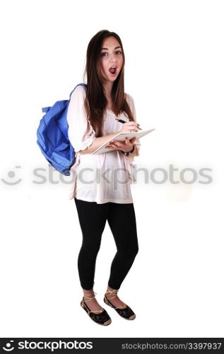 An surprised teenager with a blue backpack over her shoulder in anbeige blouse and black tights, with a notebook in her hand, over white.