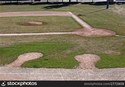 An unoccupied baseball field featuring on deck circles, shot from the bleachers.. On Deck
