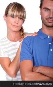 An unsure woman touching her husband&acute;s shoulder