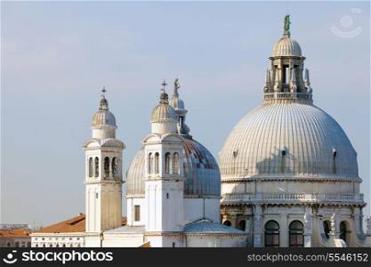 An unusual view of the domes and towers of the plague church Santa Maria della Salute at the entrance to the Grand Canal in Venice, Greece.