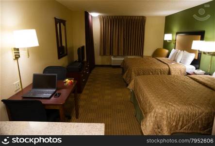 An upscale hotel room with kitchen and desk