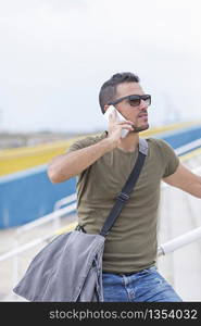 An urban man using a phone on the street