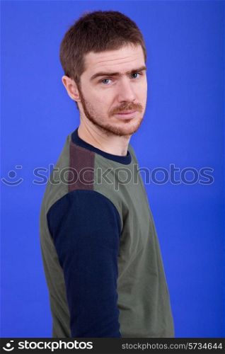 an young man portrait over a blue background