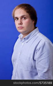 an young man portrait over a blue background