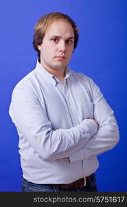 an young man portrait over a blue background